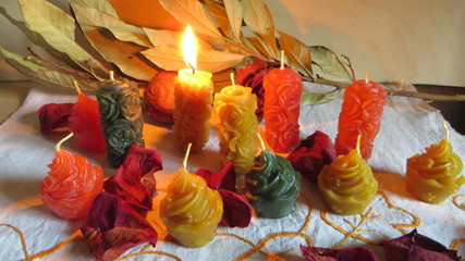 Wax candles in different colors and shapes and decorations in a simple composition