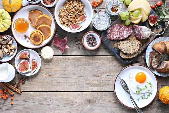 Thanksgiving Brunch. Autumn family breakfast or brunch set served on rustic wooden table. Overhead view, copy space