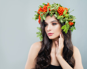 Beautiful woman in floral wreath, portrait. Female model with healthy skin, curly hairstyle, natural makeup