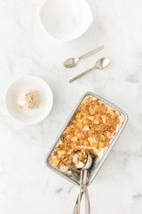 Apple Crumble Ice Cream in Container with Ice Cream Scoop