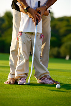 Men playing golf on lawn