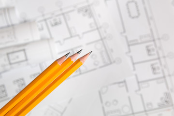 yellow pencil on architectural blueprint background