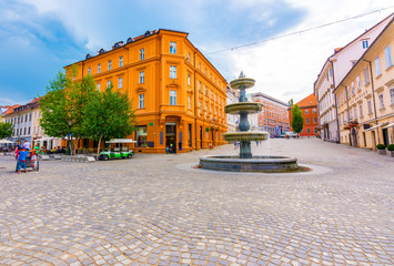 Ljubljana fountain on the city square. Old architecture and historic buildings in Slovenia capital city. Beautiful panorama of old city street