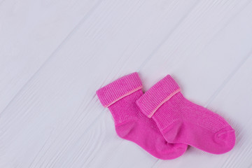 Colourful pink warm winter socks and copyspace.