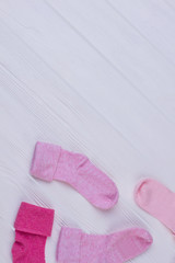 Pile of pink socks on wood with copyspace.