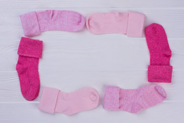 Pink baby socks neatly lying around.