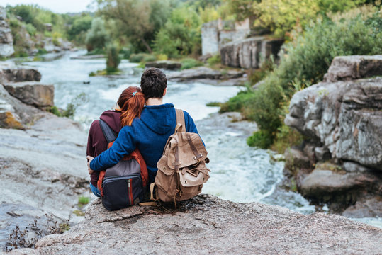 Young couple looking at natural canyon with view of the mountain river. Concept of travel.