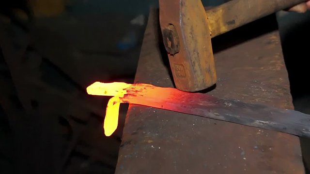 metal forging, Blacksmith forging red hot iron on anvil, Forging hot metal in smithy, 