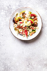 Salad with figs Mozzarella Thymean, Cedar Nut and honey.Healthy Food on the Stone Background. Nutrition Concept.Top View.Copy space for Text.