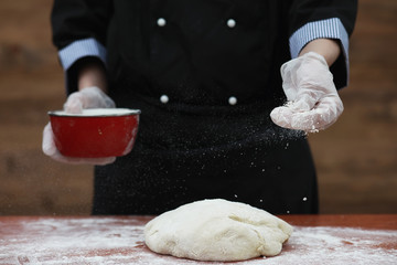 the cook makes flour for baking on the table