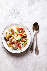Salad with figs Mozzarella Thymean, Cedar Nut and honey.Healthy Food on the Stone Background. Nutrition Concept.Top View.Copy space for Text.