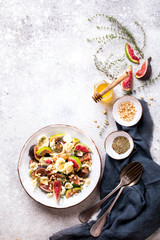Salad with figs Mozzarella Thymean, Cedar Nut and honey.Healthy Food on the Stone Background. Nutrition Concept.Top View.Copy space for Text.