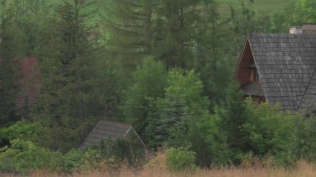 Poland,Zakopane, View of the highlander hut. In the background of mountains TATRY, Clouds. Trees and meadows. Sleeping knight and cross at Giewont. Sunrise. Panning camera, Pan, Closeup