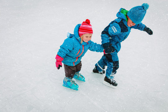 Little Boy And Girl Skating Together, Kids Winter Sport