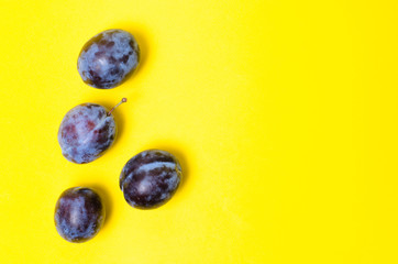 Ripe plum on yellow background.Fruits and vitamins.