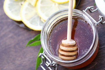 Fresh honey with a cup of black tea