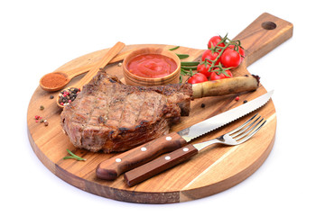 Tomahawk steak with spices and vegetables on a white background