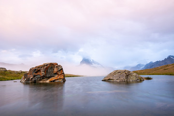 Fog rolling in at lake Stellisee with a view of the Matterhorn