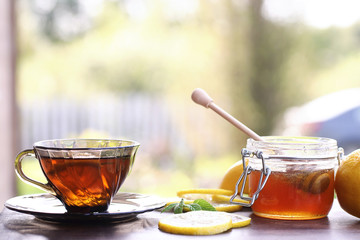 Fresh honey with a cup of black tea