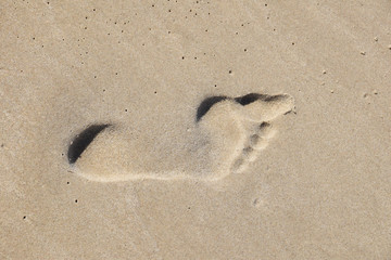 Footprint on the sand with an empty place for text