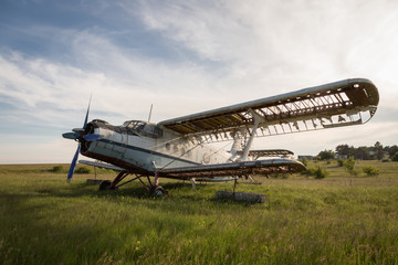 Abandoned old airplane on the field