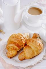 Fresh croissants for breakfast and coffee with milk