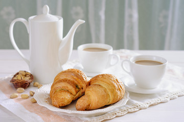 Fresh croissants for breakfast and coffee with milk