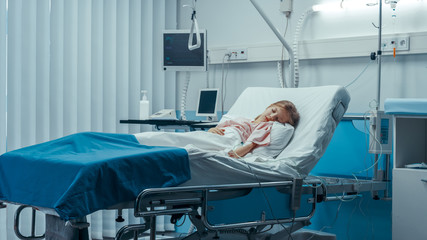 Cute Little Sick Girl Sleeps on a Bed in the Children's Hospital. Modern Pediatric Ward with Top...