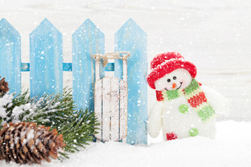 Christmas snowman and sledge toys and fir tree branch