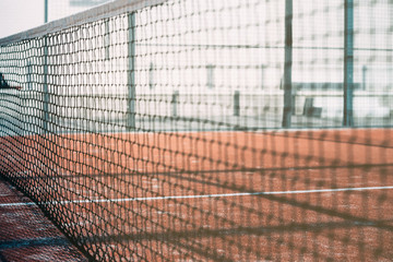 net in a padel court with orange grass