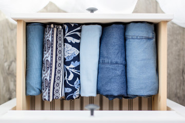 women's clothing blue folded in a chest of drawers