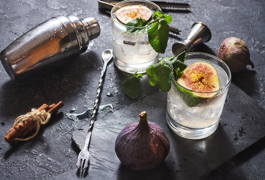 Pink fig alcoholic cocktail with cinnamon and mint