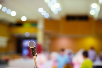 microphone in concert hall or conference room soft and blur style for background.Microphone over the Abstract blurred photo of conference hall or seminar 