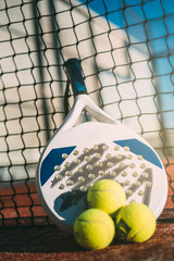 Padel blade racket resting on the net