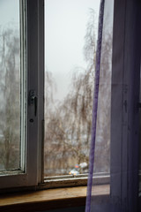 open window with purple curtains