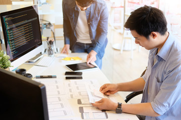 Programer Team working development software with UX UI project in computer and paper project.