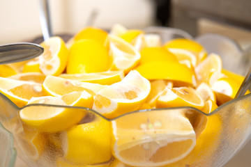 many quarter slices of fresh lemons in a glass bowl