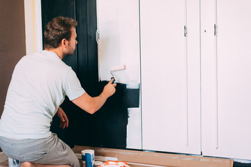 Man painting a wardrobe