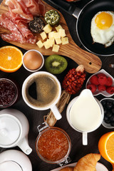 breakfast on table with bread buns, croissants, coffe and juice.