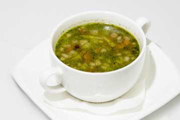 hot delicious fatty soup with vegetables and herbs in a white bowl. fresh hodgepodge. vegetarian dish