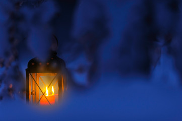 Candle lantern in the snow at dusk. Christmas time. © ekim