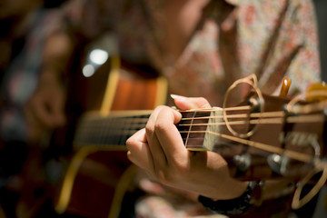 Fototapeta premium Practicing in playing guitar. Handsome young men playing guitar