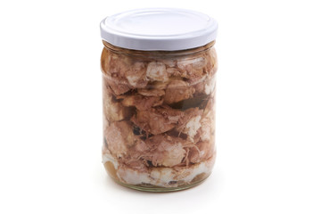 Canned meat in a glass jar, isolated on white background.