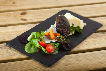 Black pudding served with mashed potatoes