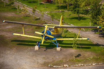Blue yellow airplane with hungarian flag and landscape background.
