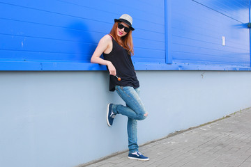 Girl hipster in a light hat and sunglasses on a summer