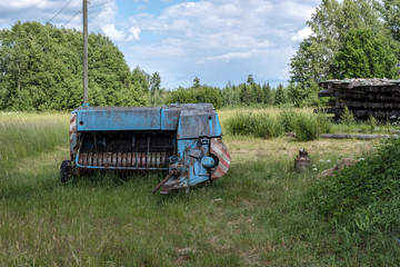 Fototapeta premium old rusty machinery in the green meadow