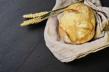 Rustic bread ball and ears of wheat