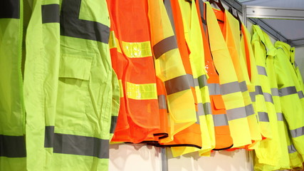 Car driver and road workers special clothing - new bright jackets with reflective stripes in...