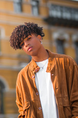 Hispanic black young man model with afro curly hair urban portrait